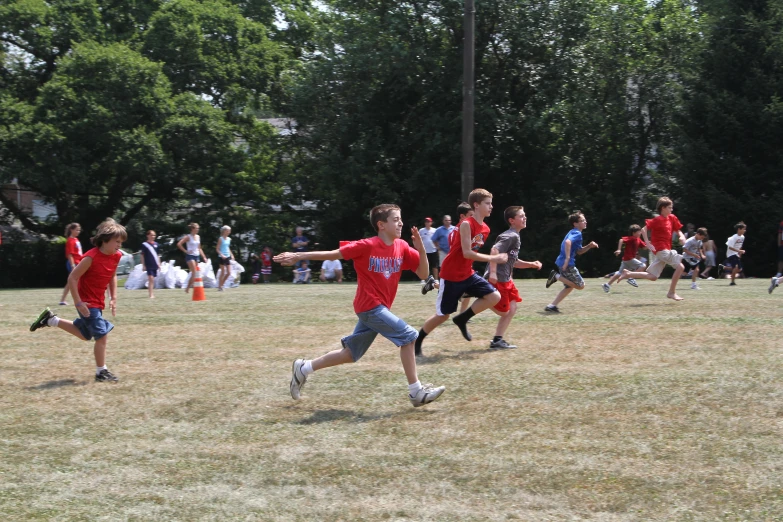 group of boys playing in a grassy field