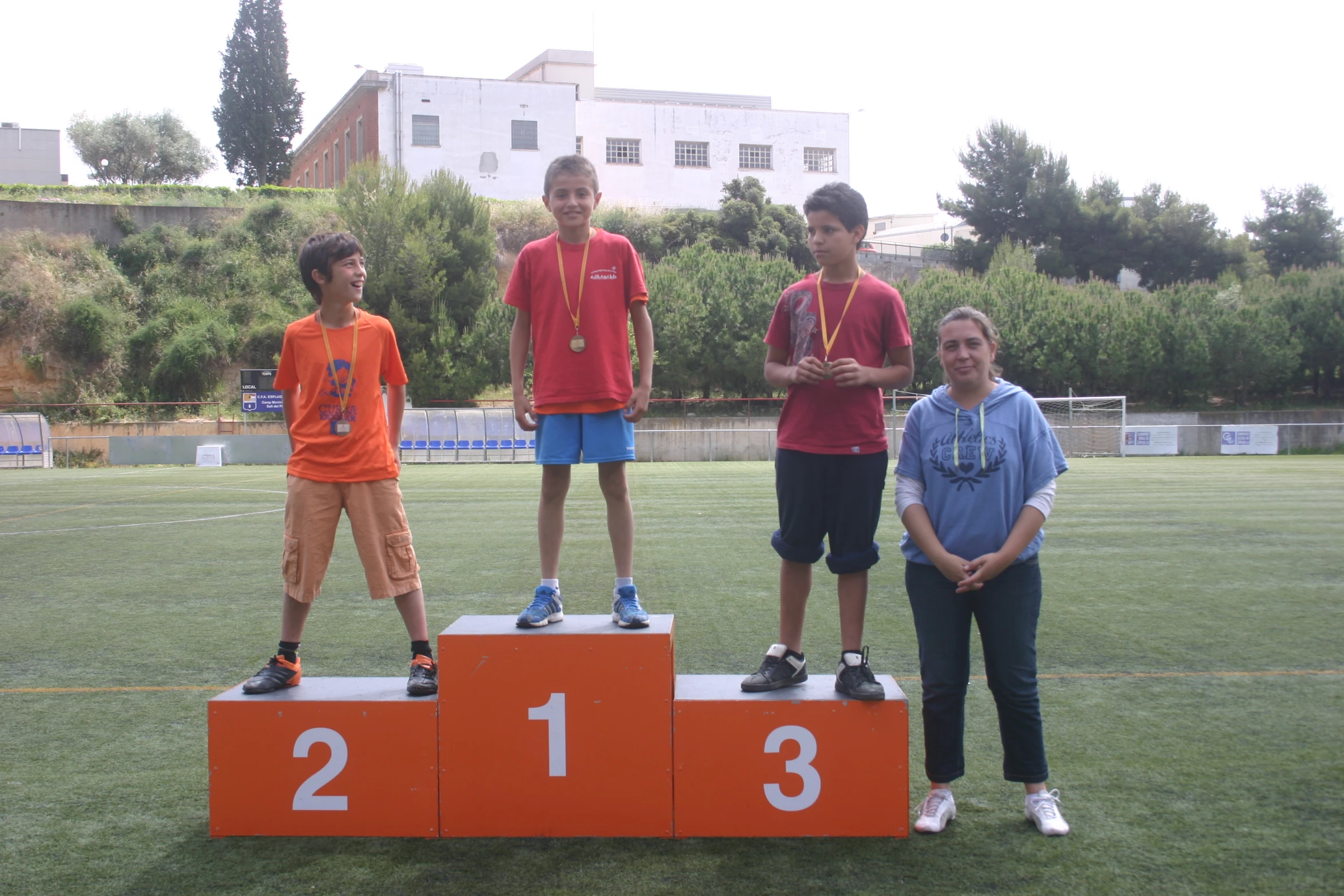 three boys standing on top of a podium