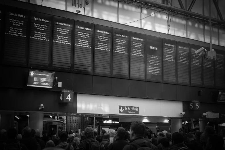 passengers standing at the doors of an airport