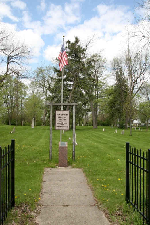 a monument is in a field with a flag