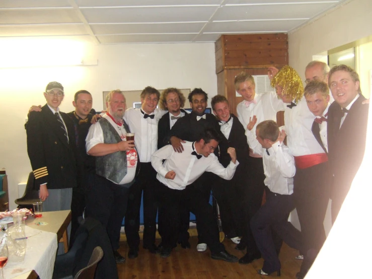 a group of people standing together on a wooden floor