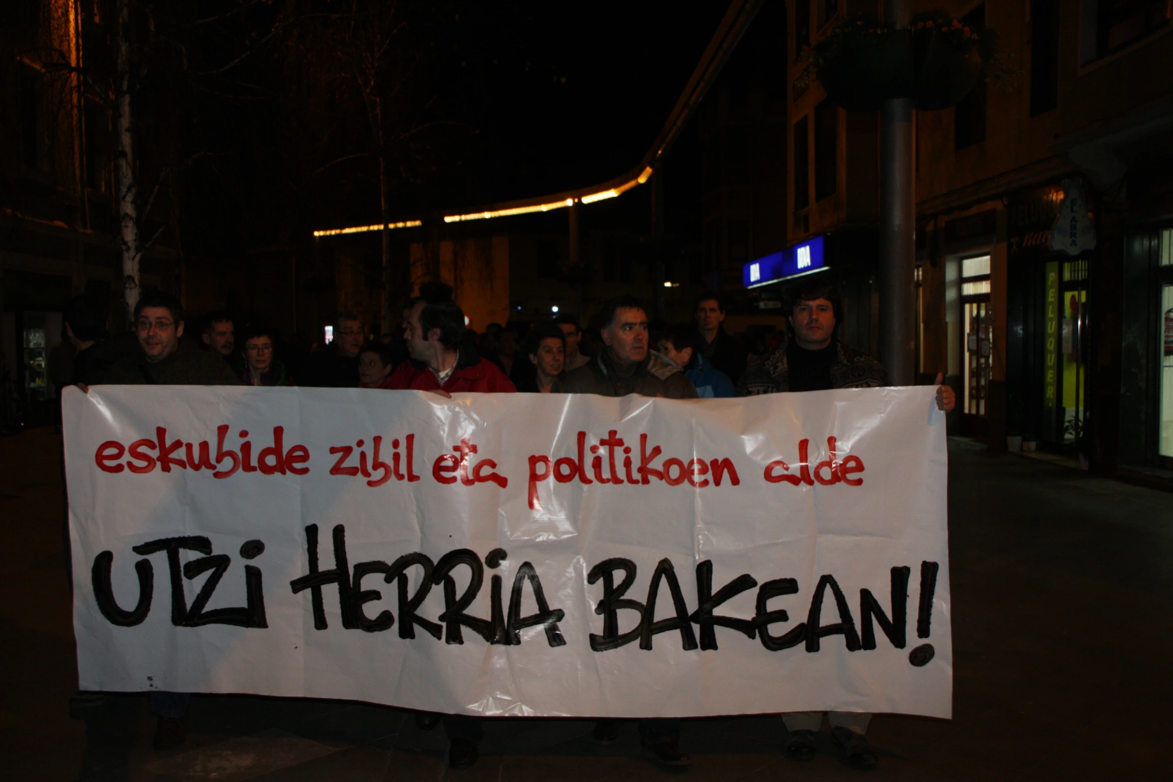 a group of people hold up a sign