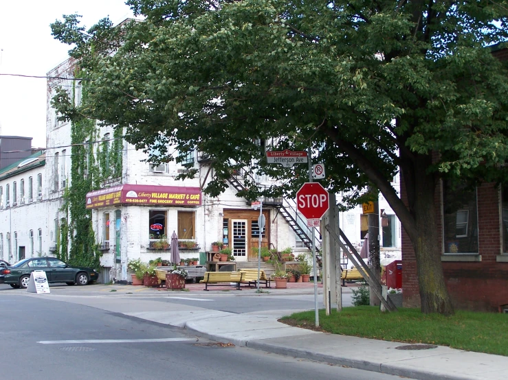 street corner with street signs and a red stop sign