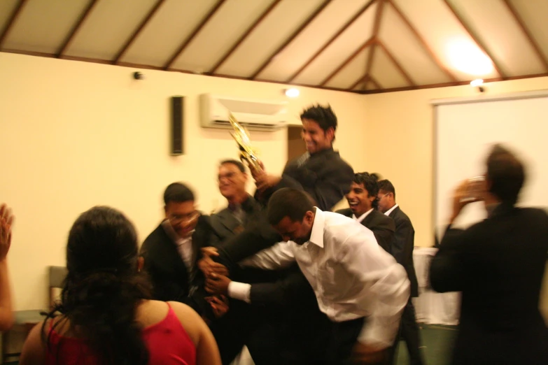 several men are being hugged in a dance