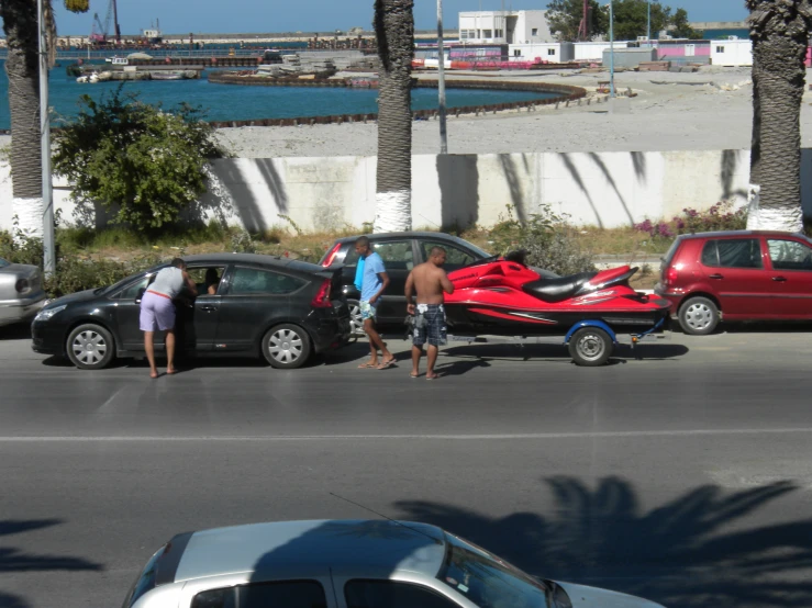 a family has crashed their vehicle at the sea shore