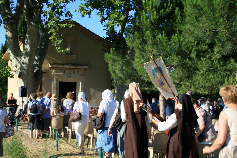 people walking and carrying their newspapers outside in front of a church