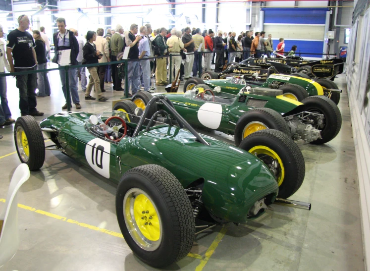 two green racing cars are shown in a row