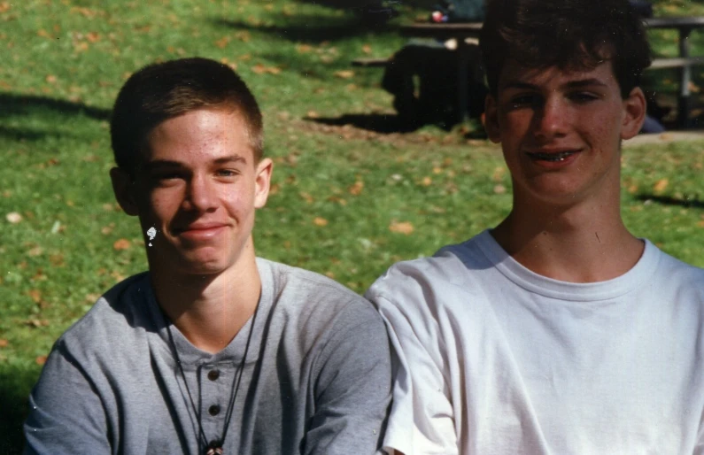 the two boys are smiling for the camera