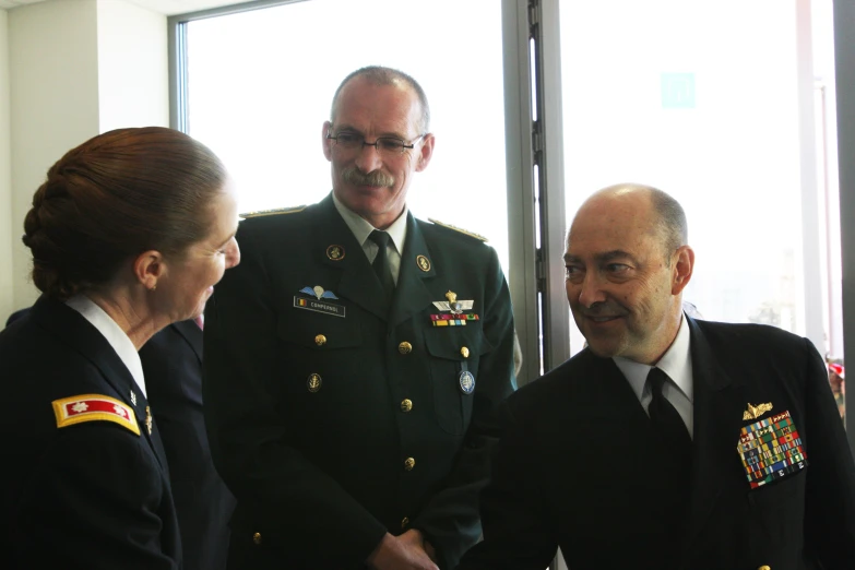 a group of men and women shaking hands