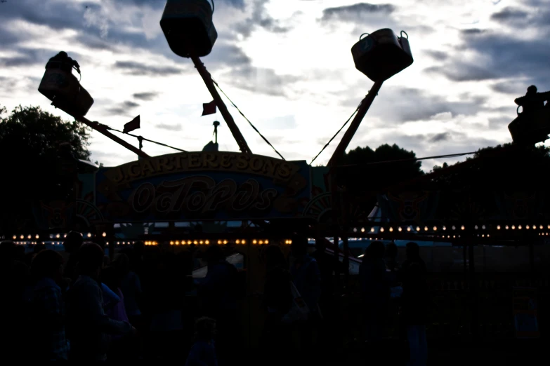 a large ferris wheel at a carnival with people watching