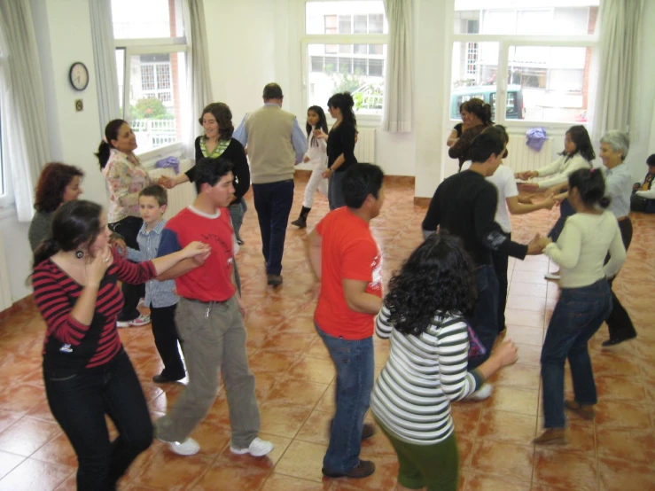 a group of people in a room dancing