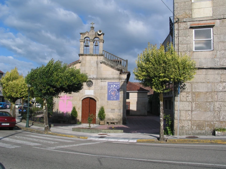 an old church with a car parked in front of it