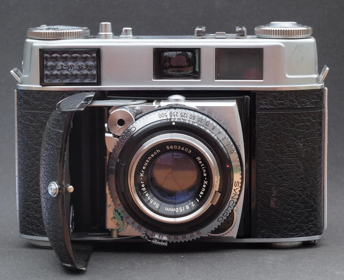 a camera with a brown leather strap