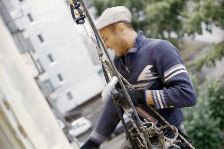 a man holding skis and a harness on his back