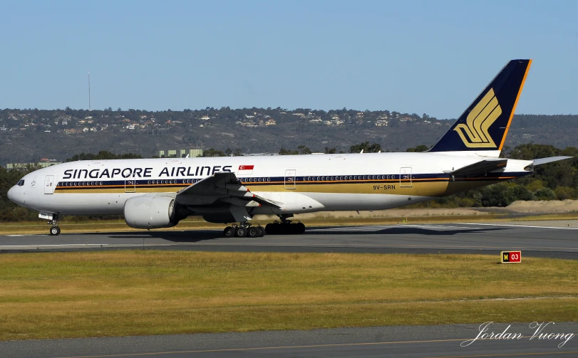 an airplane is on a runway next to grass