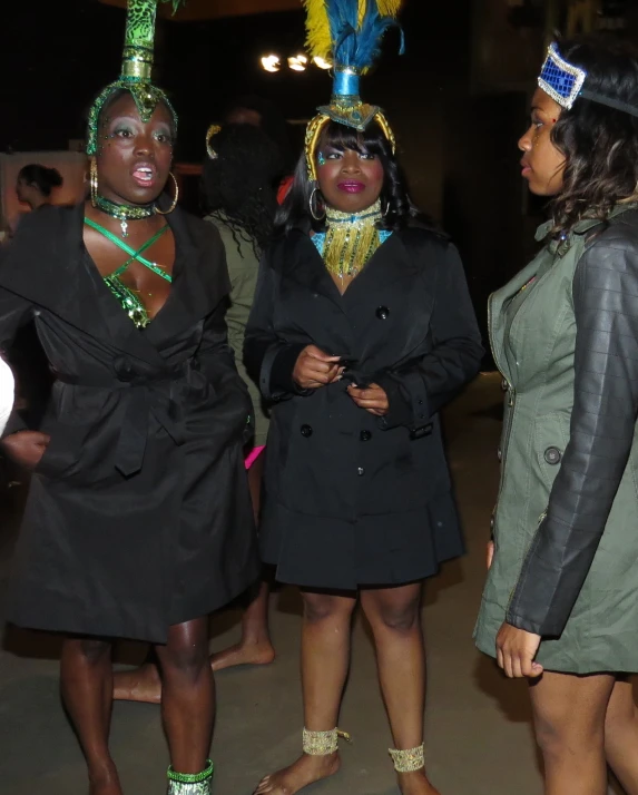 three ladies standing on the street in costume