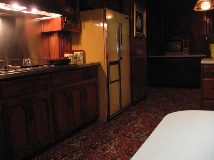 a kitchen with a counter a sink and refrigerator