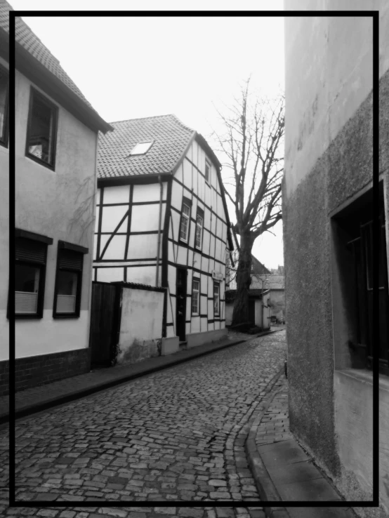 a black and white po of old houses on a cobblestone street