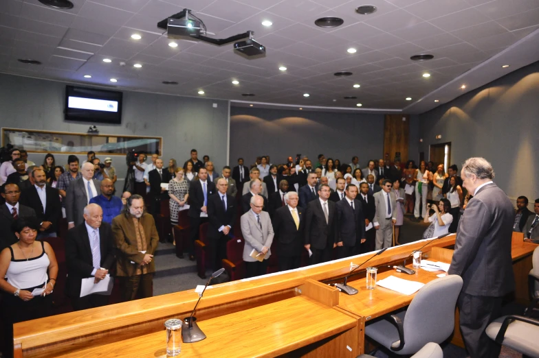 a large room full of people in suits and ties