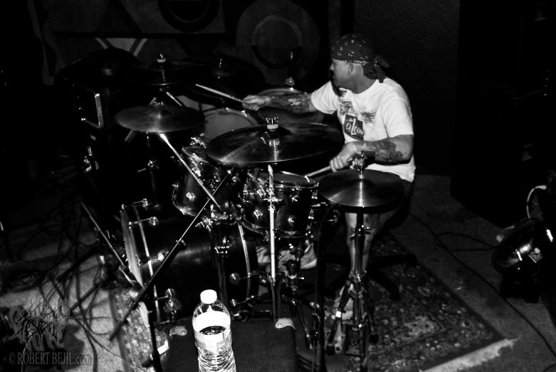 the man is playing a drumset in a recording studio