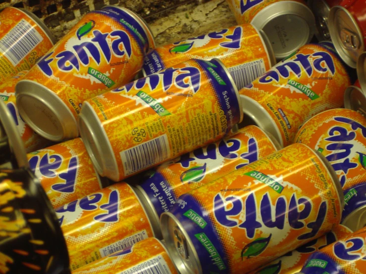 many soda cans stacked together in an industrial facility