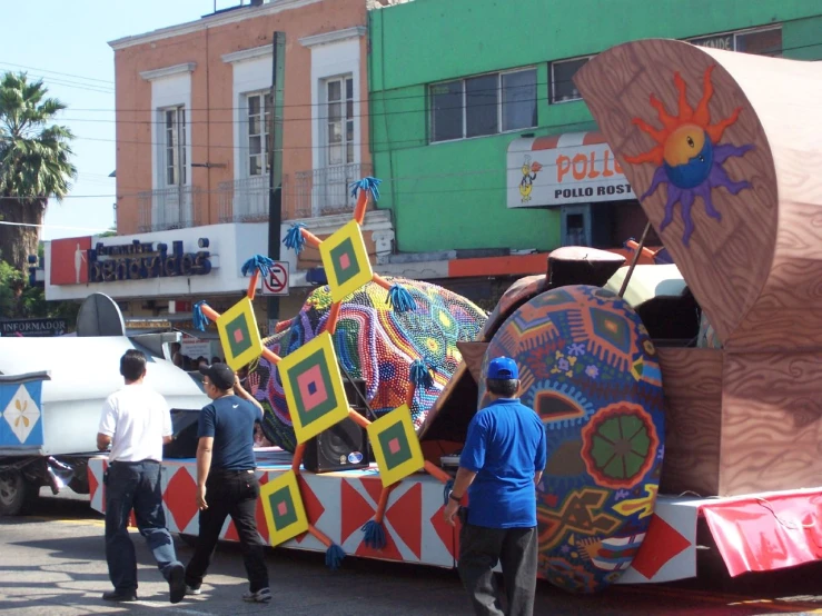 the parade float is loaded with huge artwork