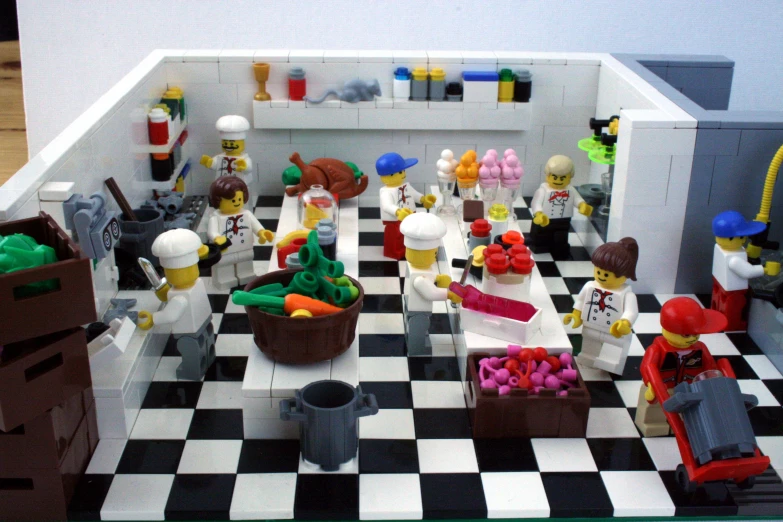 a lego kitchen with toy people cooking together