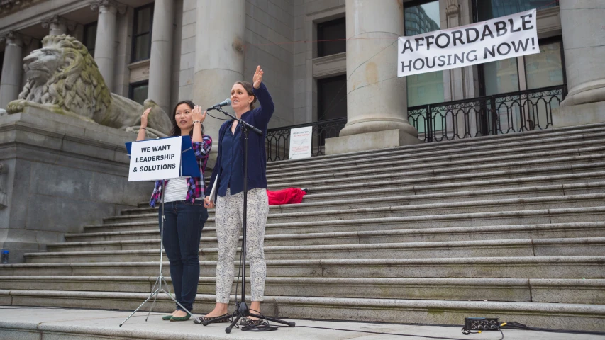 a man and two women are standing on the steps outside a building