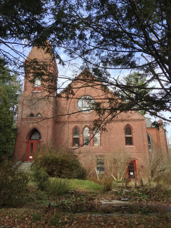 a building with trees around it and some bushes near by