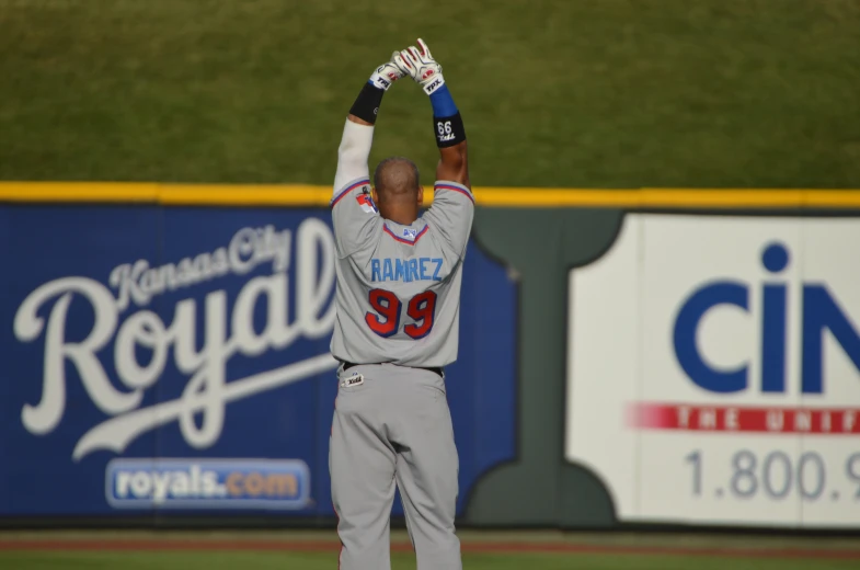 a baseball player holds his hands up in celetion