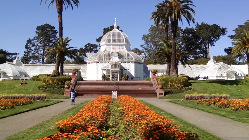 a building with stairs and lots of flowers