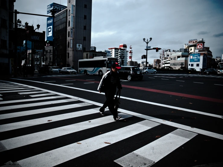 a person crossing the street at a crosswalk