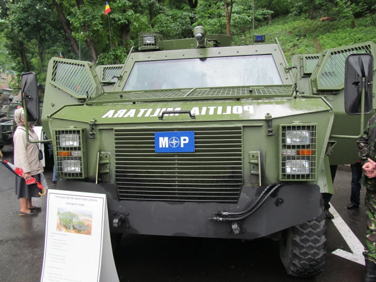 a large military vehicle parked near a hill