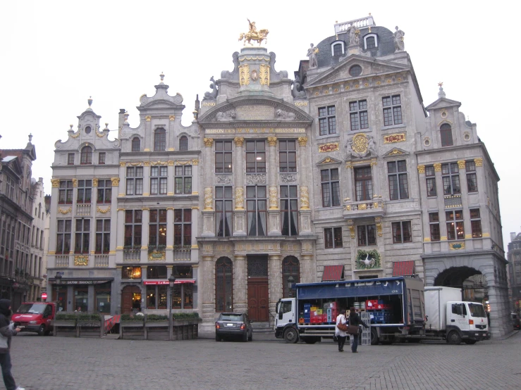 a large white building has a large clock at the top of it