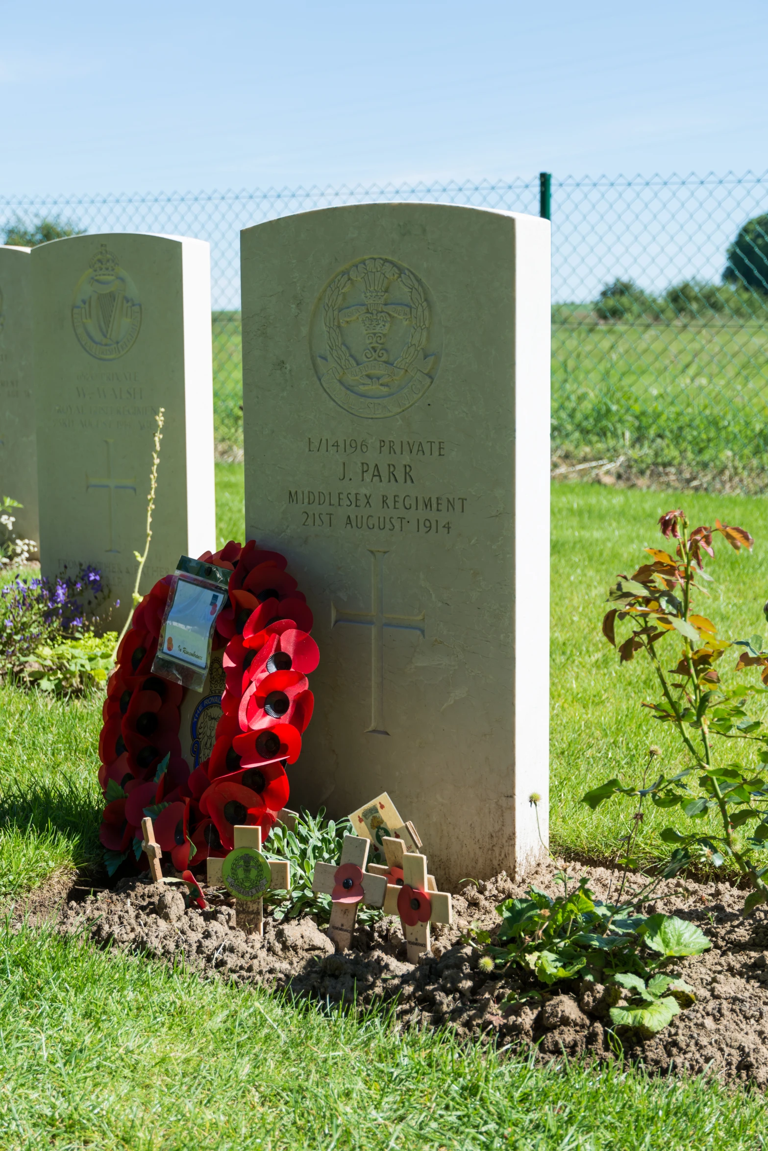 a large pair of headstones with flowers next to them