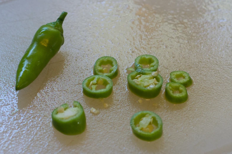 the food is green and a pepper on the counter