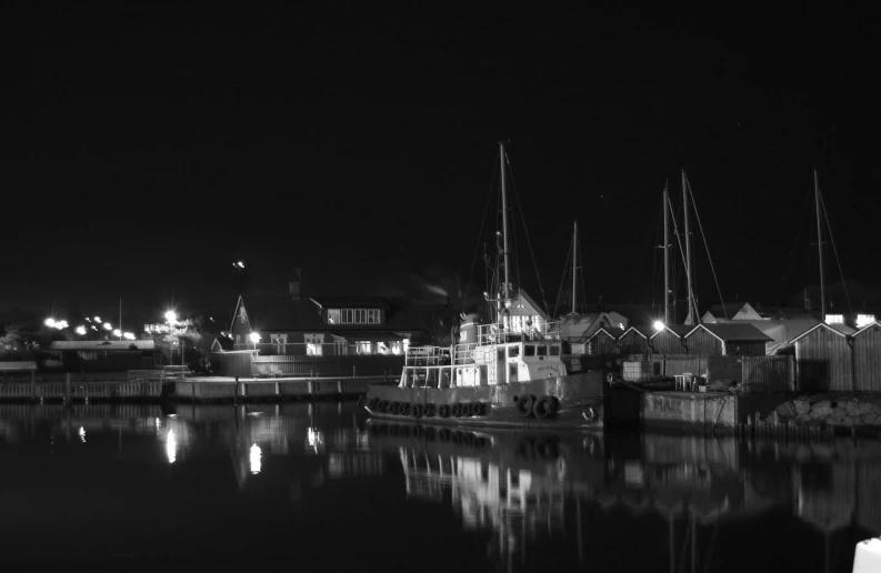 a couple of boats are docked at the water