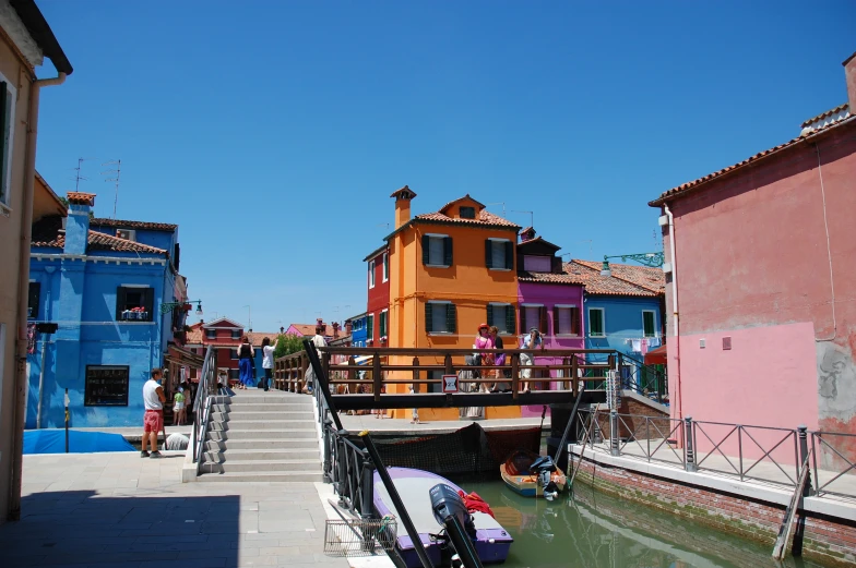 a canal with houses painted a different color in a town