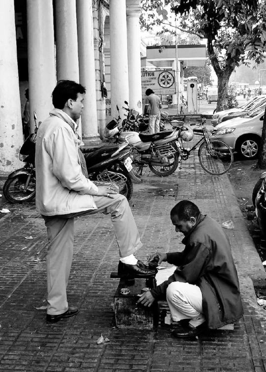 two men with bicycles on a city street