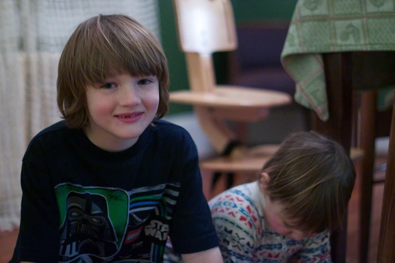 a boy and a girl smile while standing next to each other