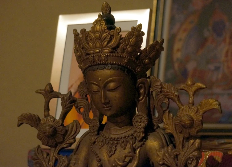 a statue of a female with gold crown