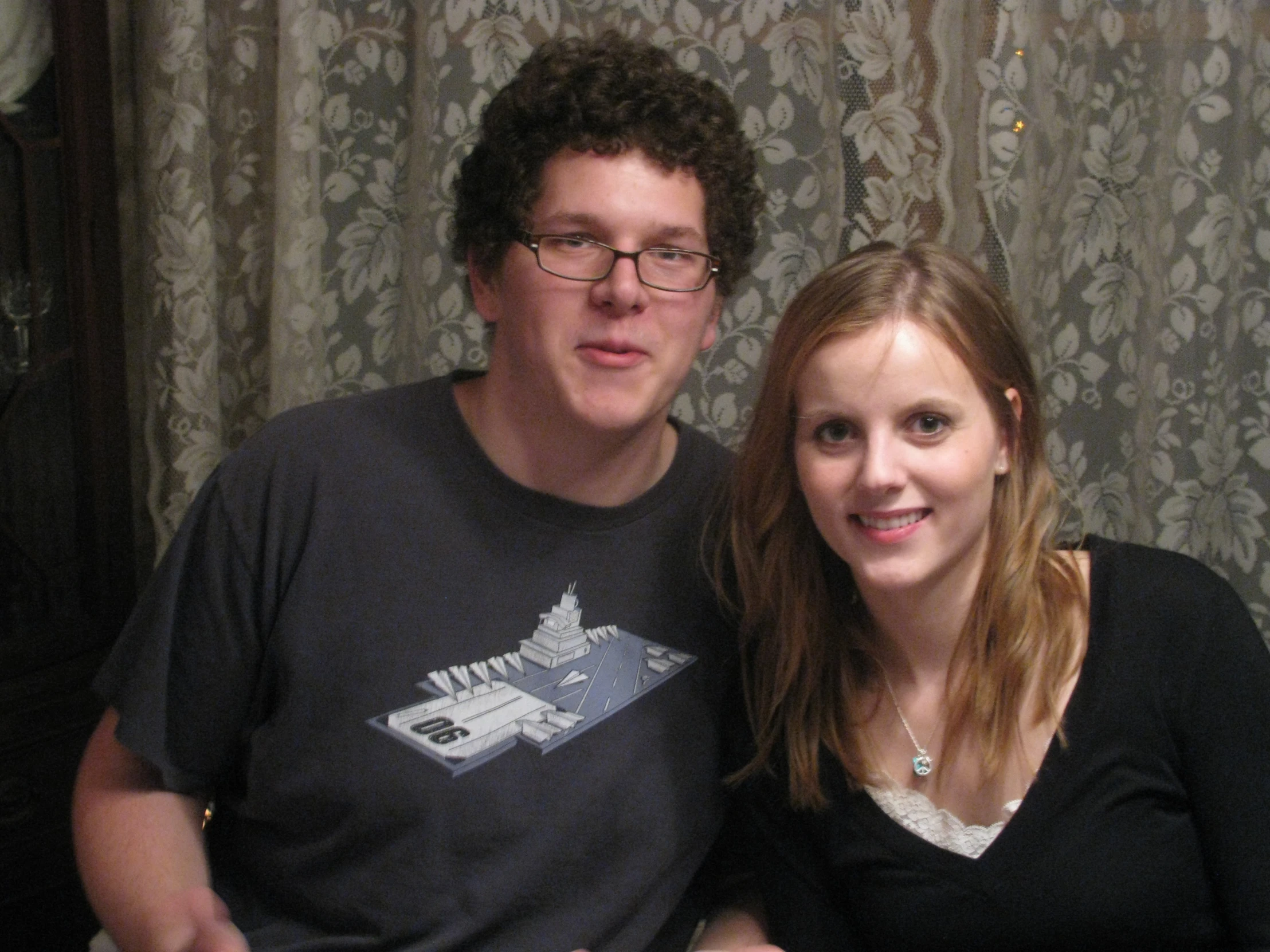 a woman is smiling as she stands next to a man