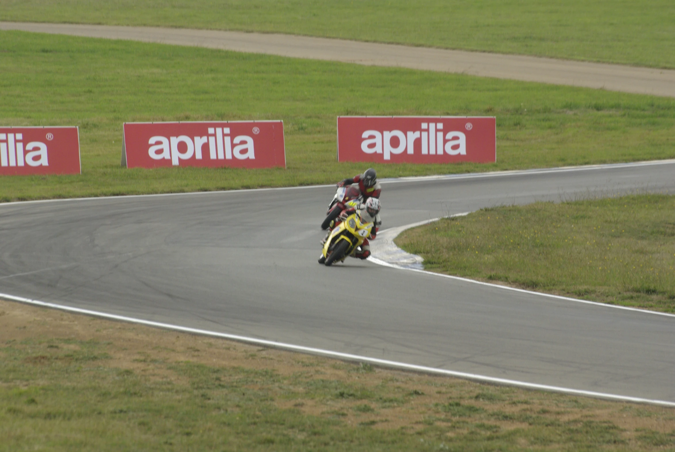 a man riding on the back of a yellow motorcycle