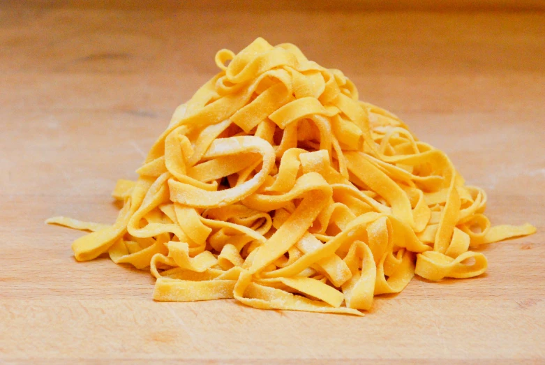 a pile of noodles sitting on top of a wooden table