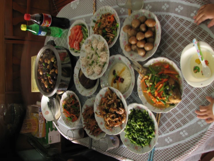 children are eating rice in a very small amount of dishes