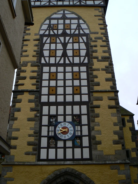 the large clock has been painted on the wall of the building