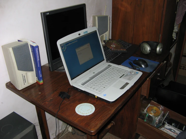a table with two laptops on it and a mouse