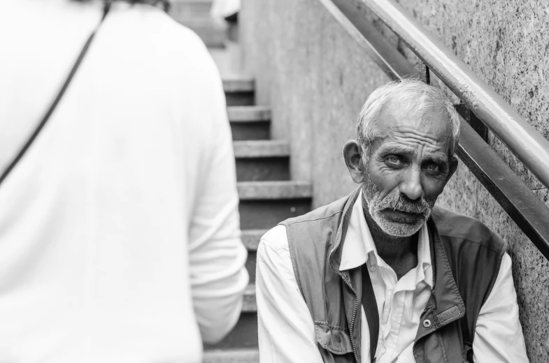 the old man with a beard is walking up stairs