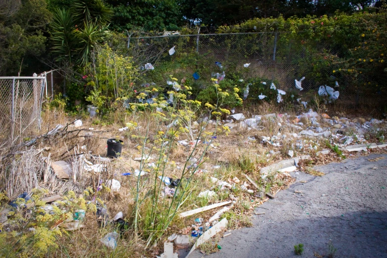 a bunch of trash sitting outside near a fence