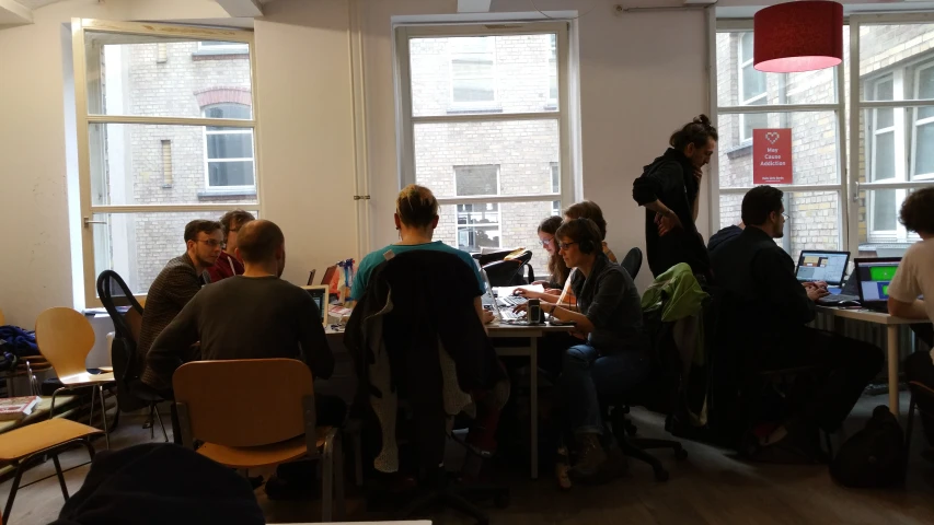 several people sit around a table in an office setting